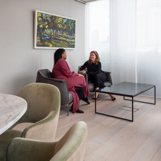 Two Barings teammates meeting in a lounge room in our London office.