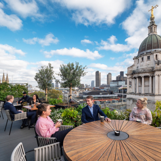 Group of teammates meeting on the terrace of the London office.