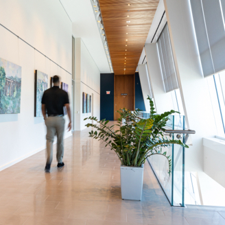 Teammate walking through the gallery hallway in Charlotte office headquarters.