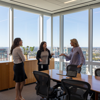 Group of teammates meeting in a conference room in the Charlotte office.