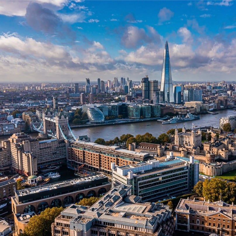 Aerial panoramic scene of the London city financial district with many iconic skyscrapers near river Thames.
