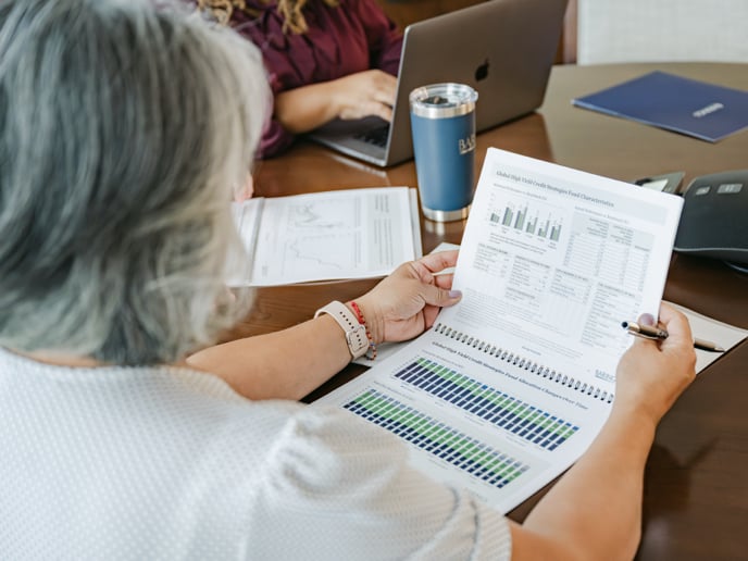 Person reviewing business materials during a meeting.