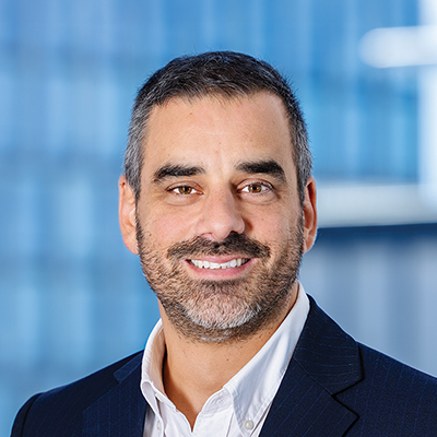 Headshot of Joseph Ajaka smiling at the camera.