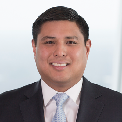 Headshot of Alan Alegado smiling at the camera.