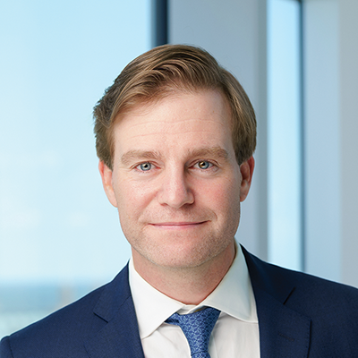 Headshot of Adam Cash smiling at the camera.