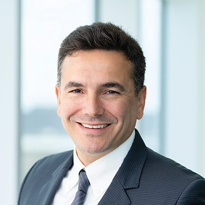Headshot of Burak Cetin smiling at the camera.