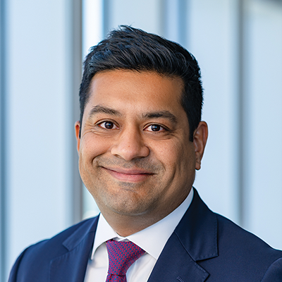 Headshot of Satya Chakravarty smiling at the camera.