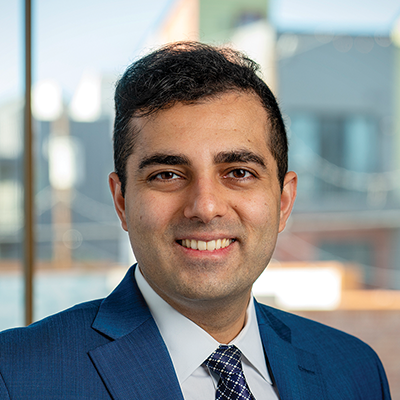Headshot of Shubz Chandna smiling at the camera.