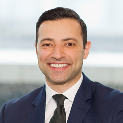 Headshot of Adnan El-Araby smiling at the camera.