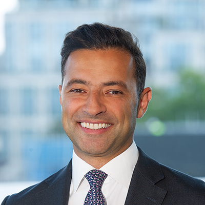 Headshot of Adnan El-Araby smiling at the camera.