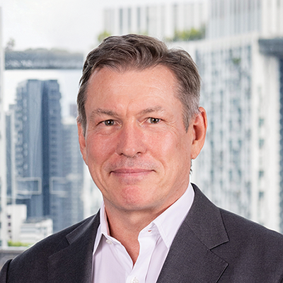 Headshot of Michael Flynn smiling at the camera.