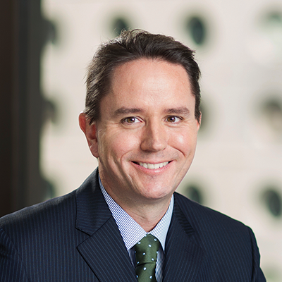 Headshot of Shane Forster smiling at the camera.