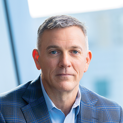 Headshot of Mike Freno smiling at the camera.