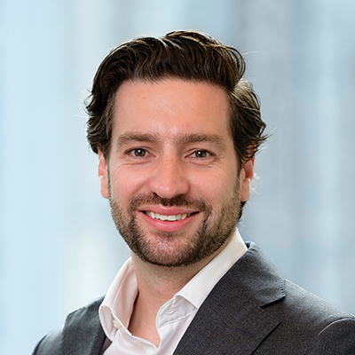 Headshot of Philip Grech smiling at the camera.
