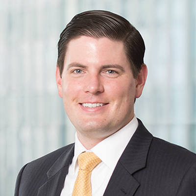 Headshot of Patrick Hartman smiling at the camera.