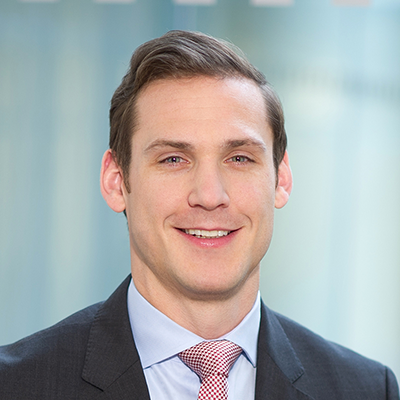 Headshot of Oliver Harker-Smith smiling at the camera.