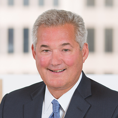 Headshot of Tom Juterbock smiling at the camera.