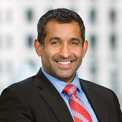 Headshot of Rishi Kapur smiling at the camera.