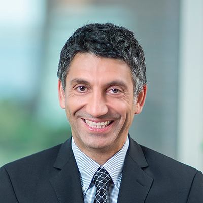Headshot of Cem Karacadag smiling at the camera.