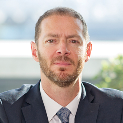 Headshot of Tom Kilpatrick smiling at the camera.