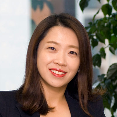 Headshot of Jasmine Kim smiling at the camera.