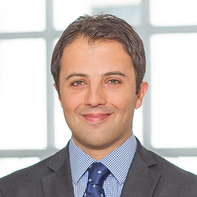 Headshot of Sam Lockhart Smith smiling at the camera.