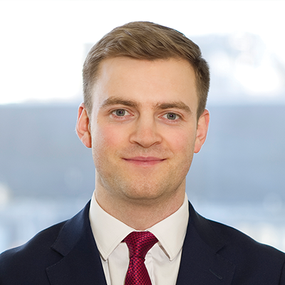 Headshot of Thomas Lowton smiling at the camera.