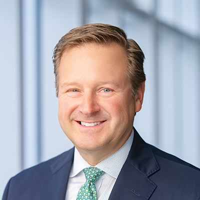 Headshot of Bill Manthrone smiling at the camera.