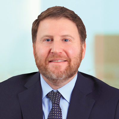 Headshot of Ben Mathias smiling at the camera.