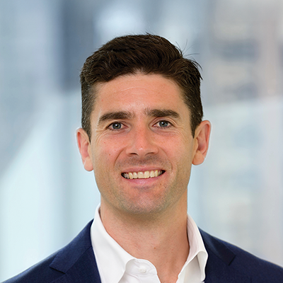 Headshot of Andrew Miller smiling at the camera.