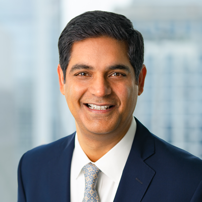 Headshot of Jawad Malik smiling at the camera.