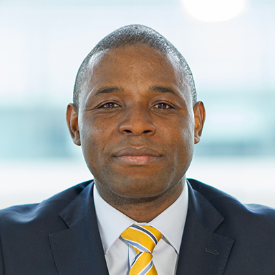 Headshot of Brian Mangwiro smiling at the camera.