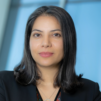 Headshot of Mina Nazemi smiling at the camera.