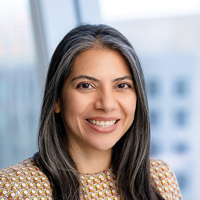 Headshot of Mina Nazemi smiling at the camera.
