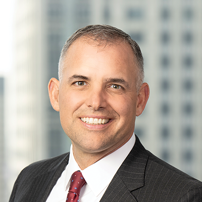 Headshot of Brian Polomsky smiling at the camera.