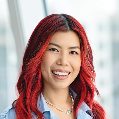 Headshot of Janice Saw smiling at the camera.