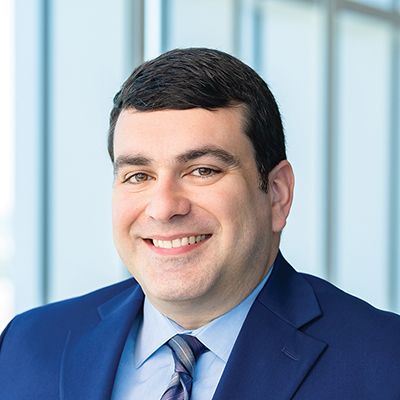 Headshot of Raffi Samkiranian smiling at the camera.