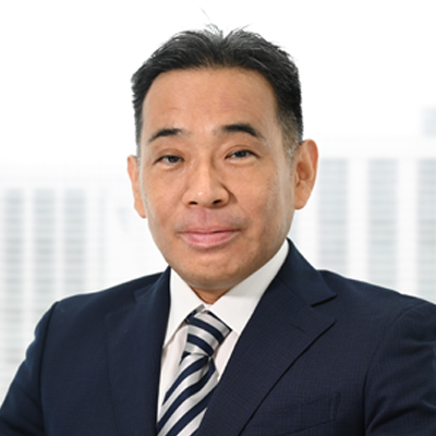 Headshot of Manabu Tamaru smiling at the camera.