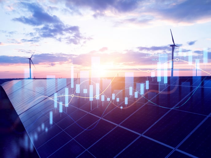 Sunset view of solar panels and wind turbines with abstract overlay of blue, yellow and red line and bar chart shapes.