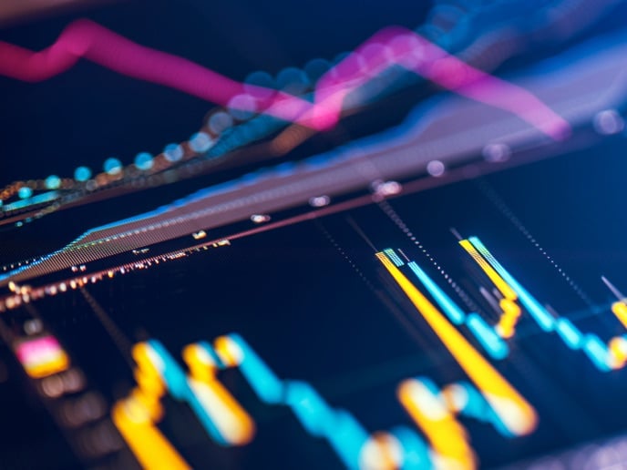 Close‑up of a digital market chart with colorful bars and trend lines representing financial performance and market movement.