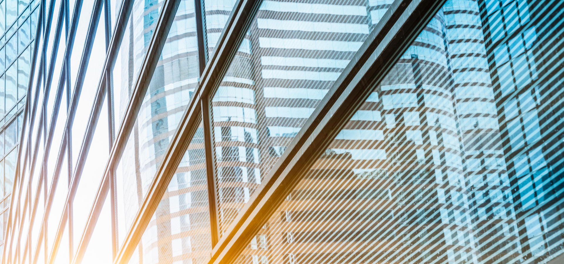 Angled view of a glass building with blue and yellow.