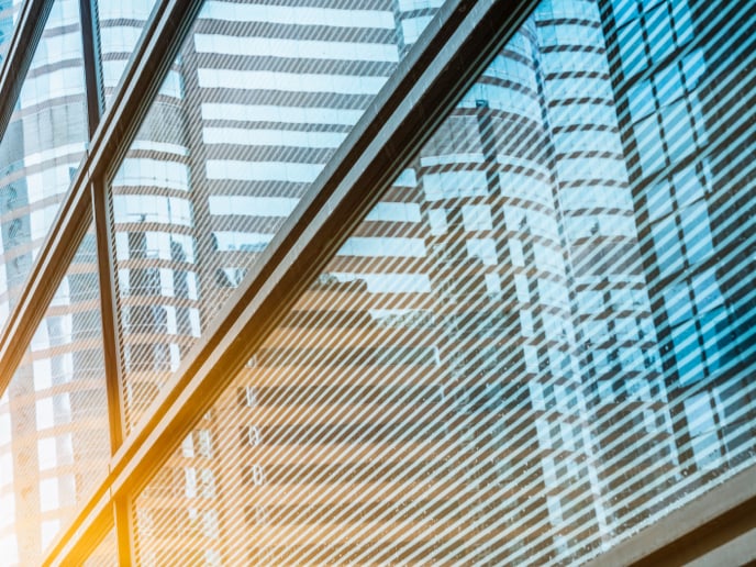 Angled view of a glass building with blue and yellow.