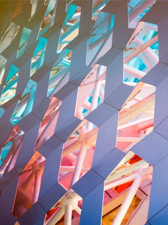 This image is a detailed architectural shot of a contemporary patterned wall, characterized by its vibrant colors and geometric complexity.