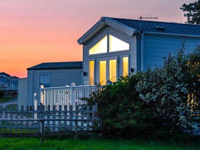 This image shows an aerial-style view of a luxurious holiday lodge at The Towans, a collection of high-end holiday homes in North Cornwall, England.