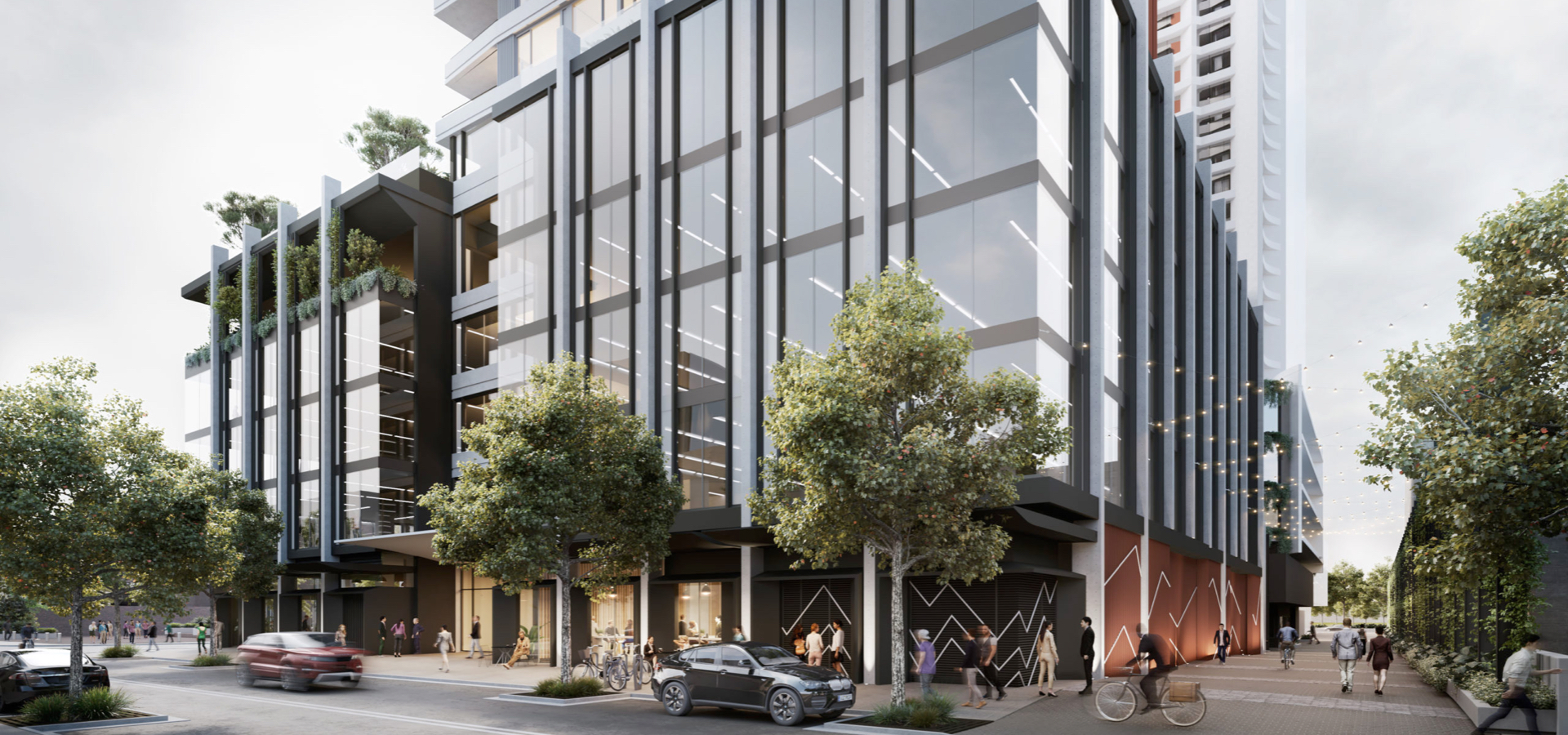A residential building with trees and people on the street.