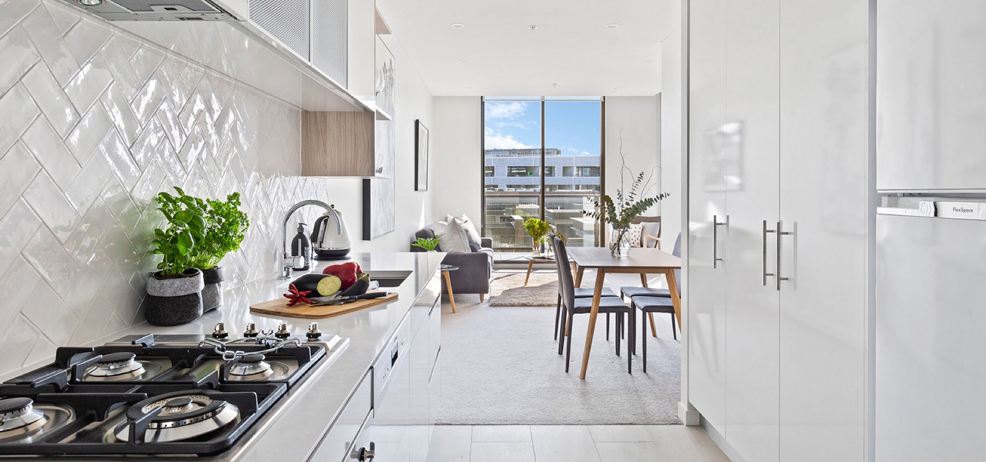 A kitchen with a table and chairs.