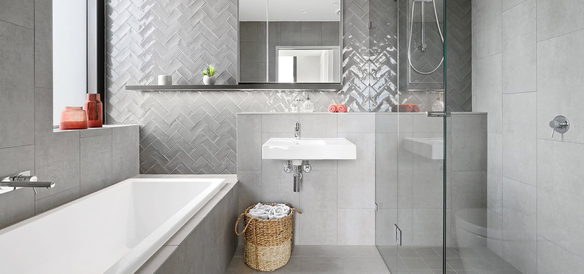 A bathroom with a tub, sink and shower.