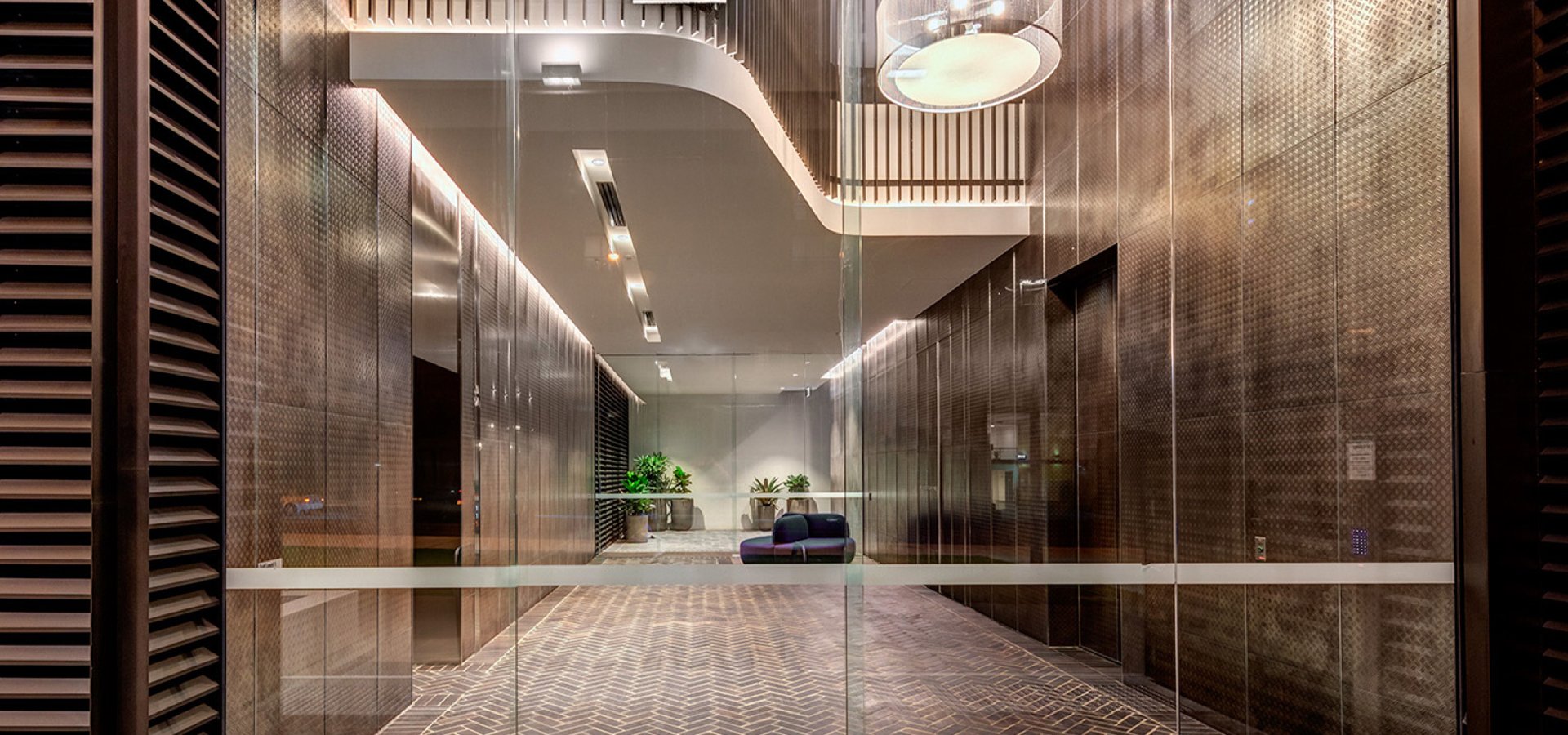 Glass doors looking into a modern residential building.