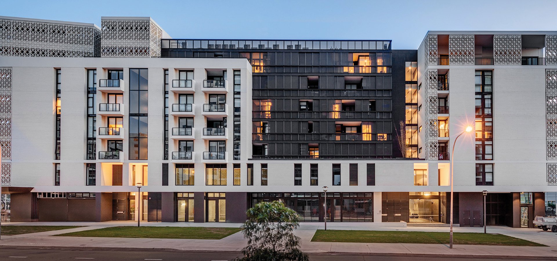 A front view of a residential building with many windows.