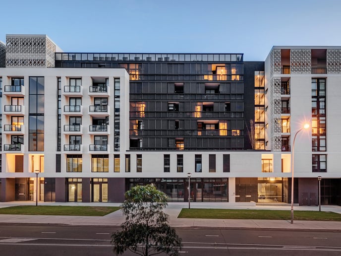 A front view of a residential building with many windows.